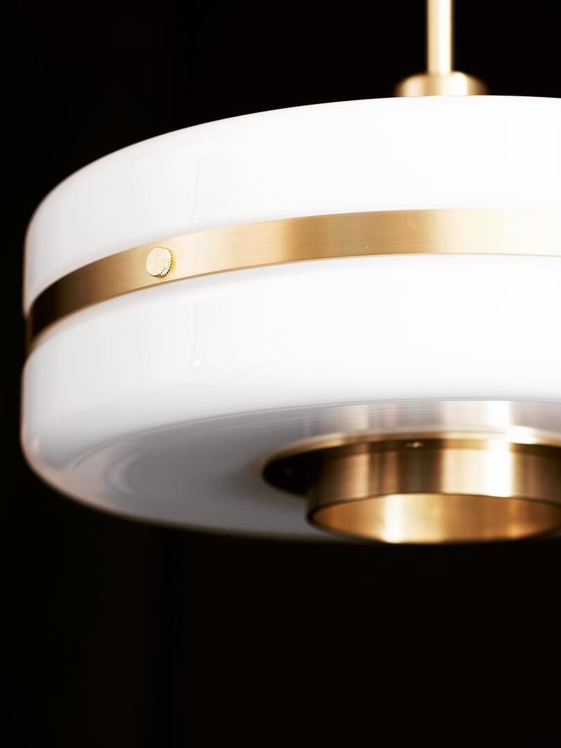 Close-up of the opal-white shade, Gold metal belt and lower cap