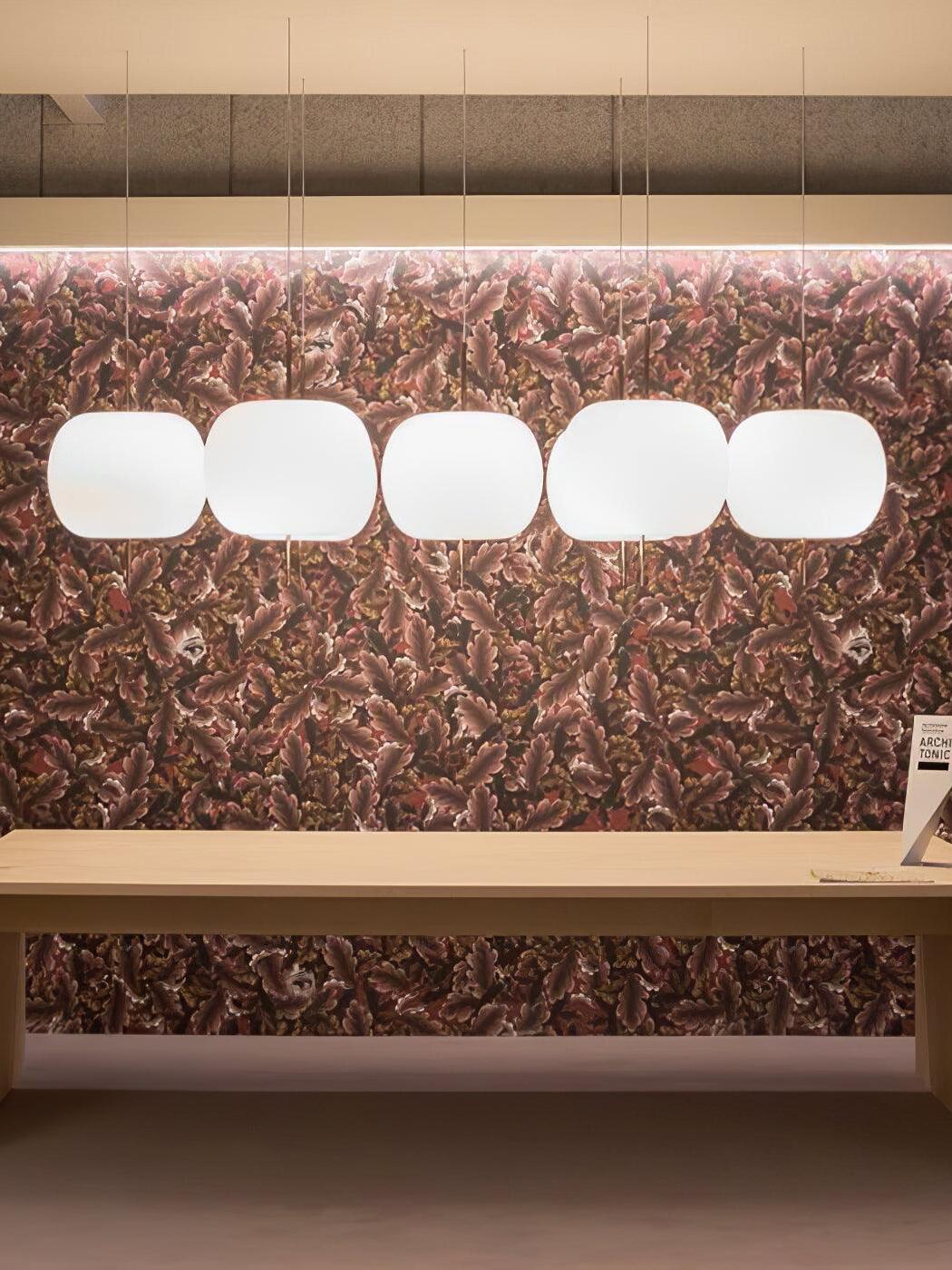 Row of white glass pendants above a long bench