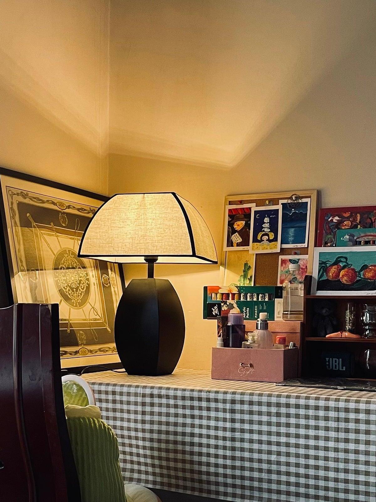 Lit Javier lamp on checked tabletop in decorated room