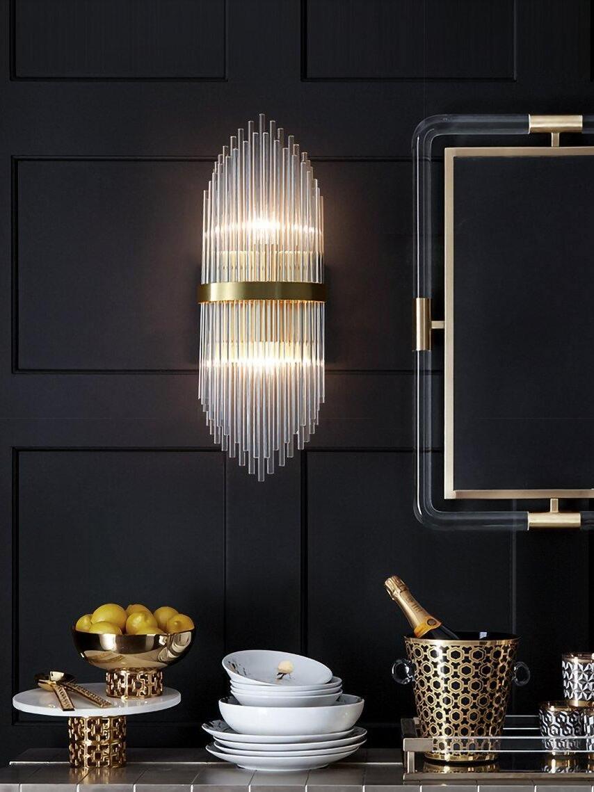 Crystal rod wall sconce beside mirror and dark panel