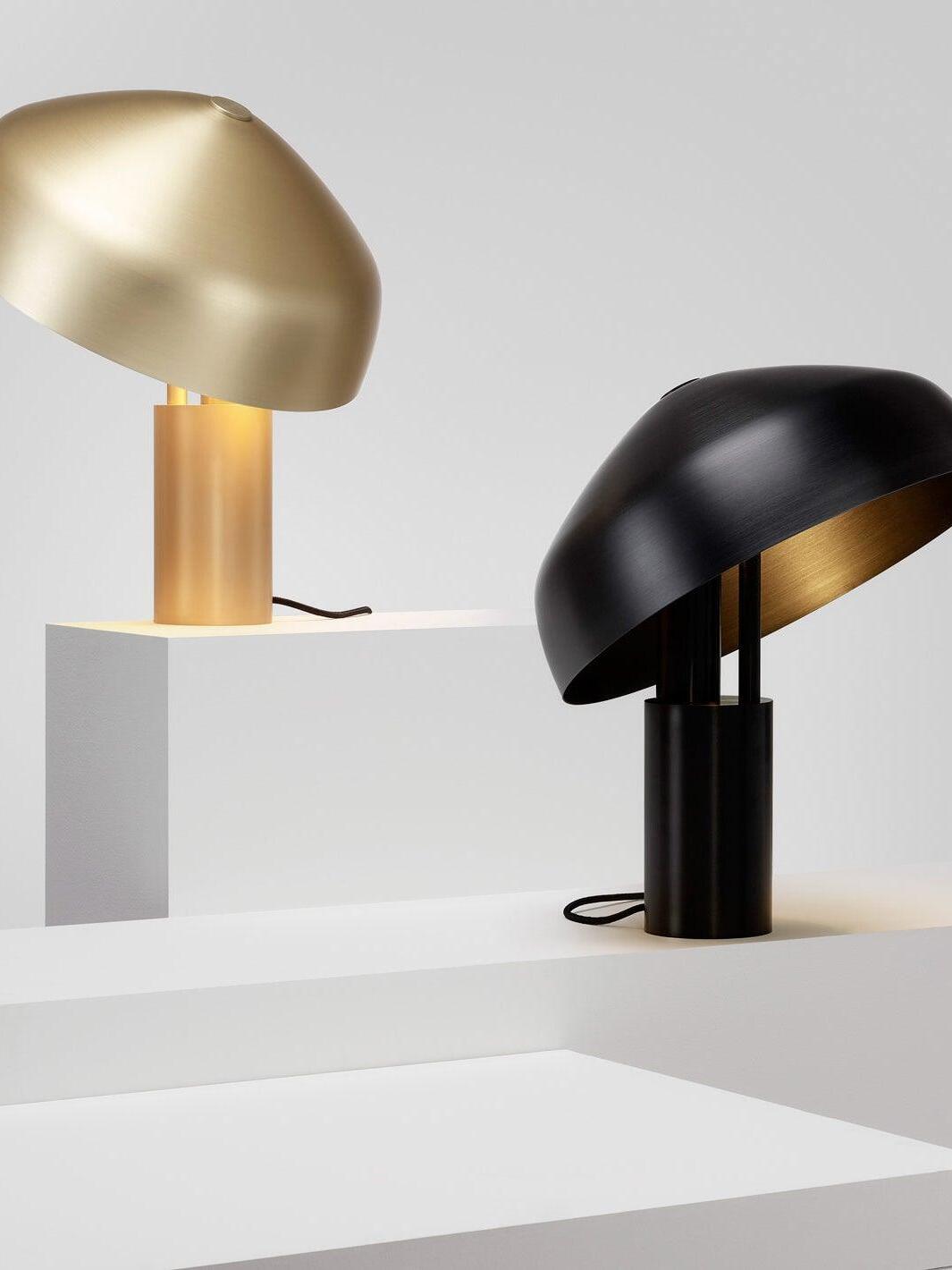Gold and black dome table lamps on white blocks