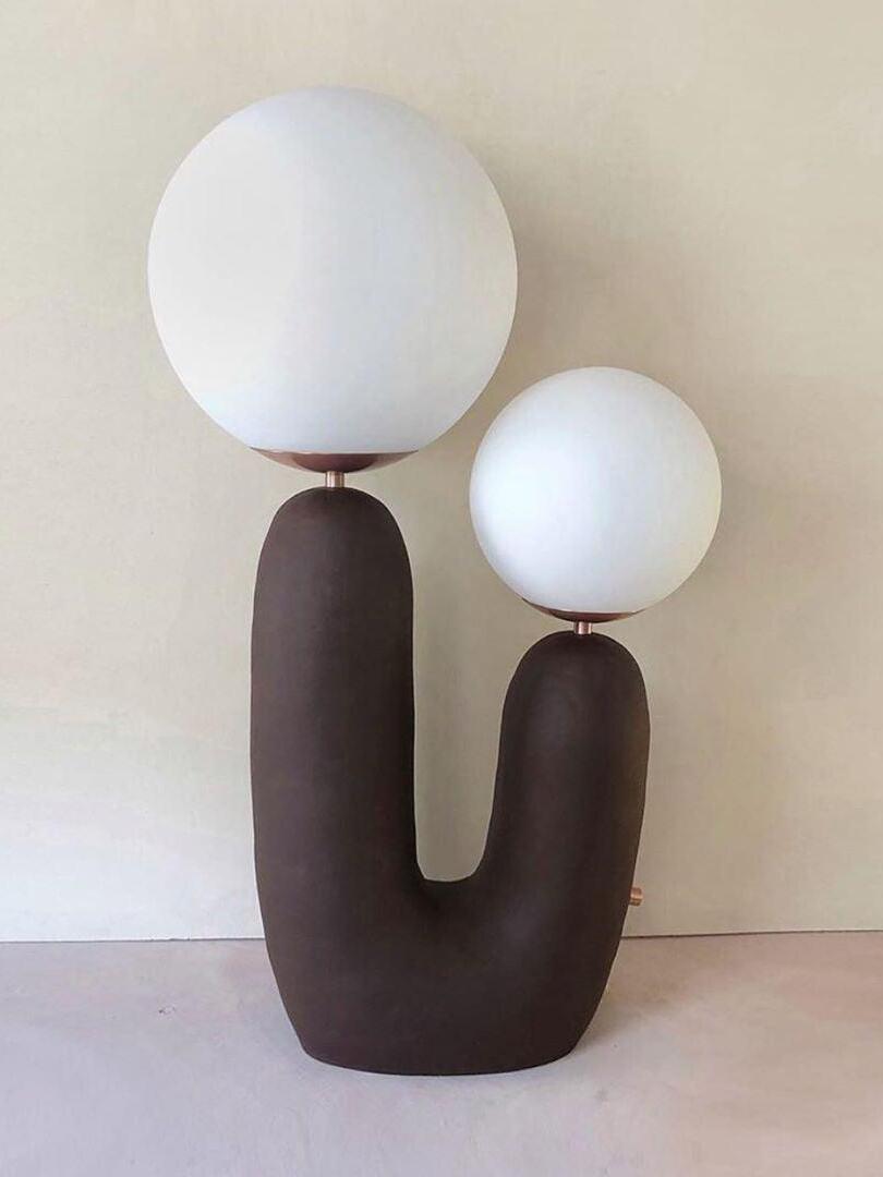 Dark Brown U-shaped lamp on a pale background