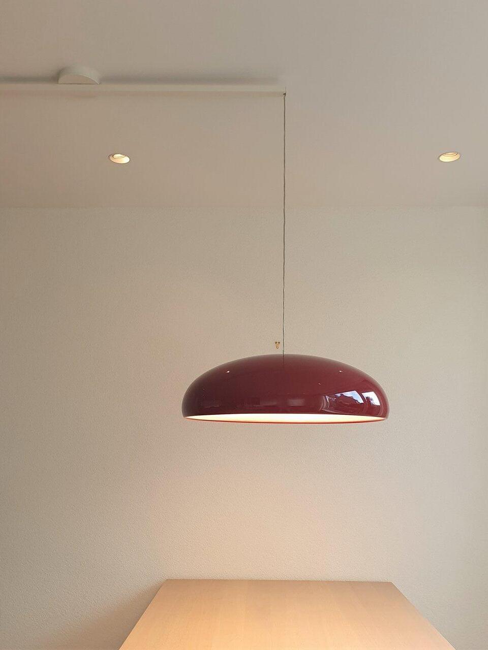 Dark red dome casting light onto a table