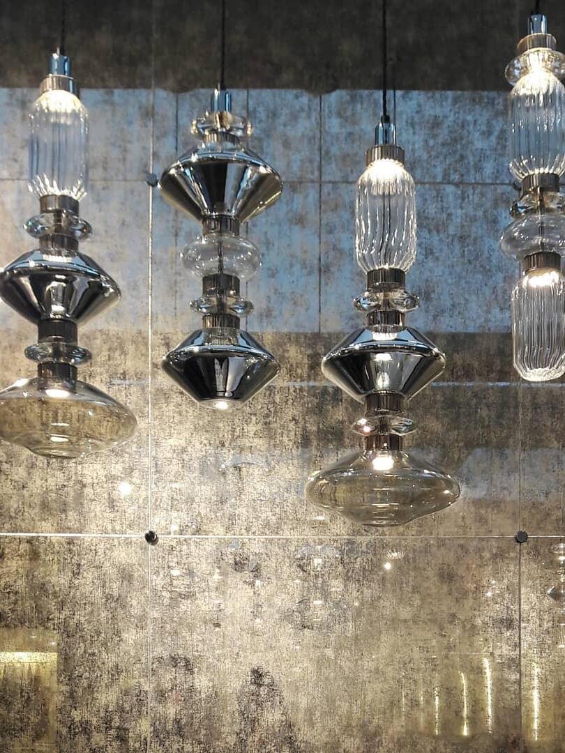 Smoky angular and ribbed clear pendants against textured wall