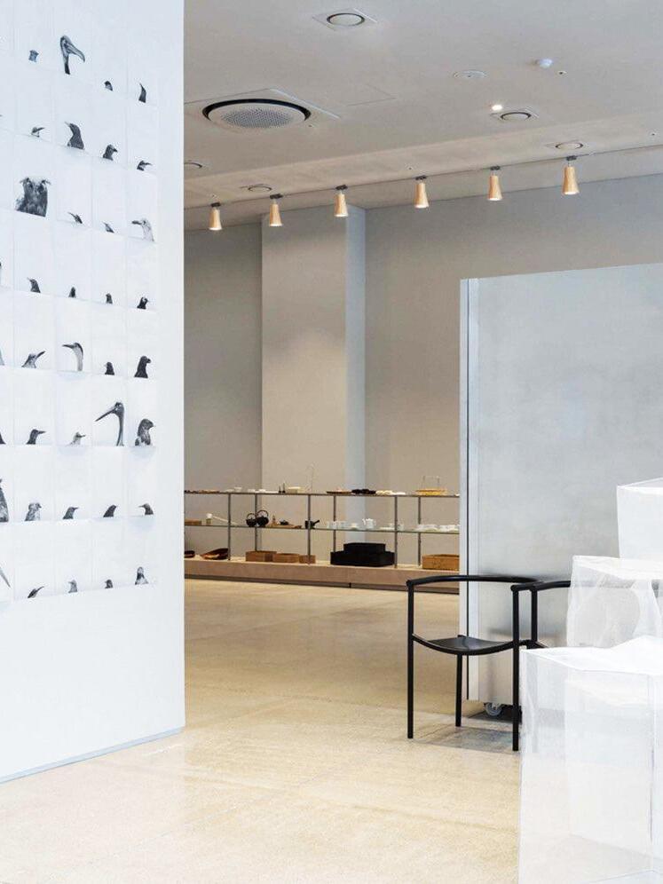 Long row of pale wooden track spotlights in retail interior