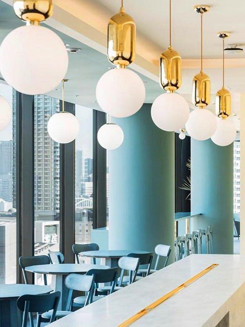 Row of globe pendants along a cafe counter