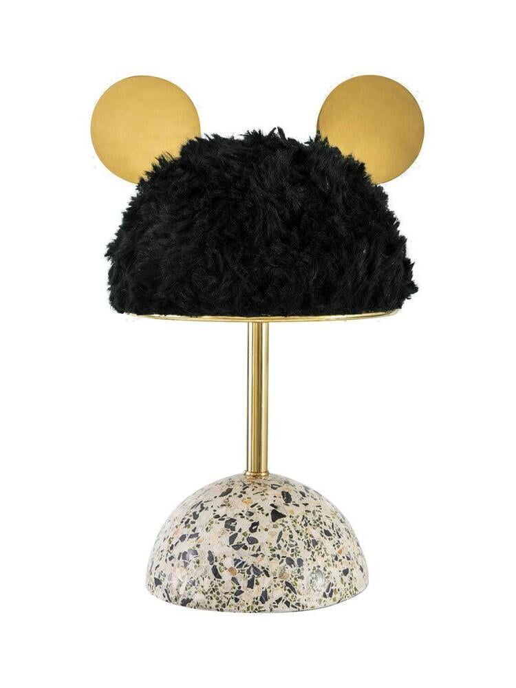Isolated dark plush shade lamp with circular gold-tone accents and rounded terrazzo base