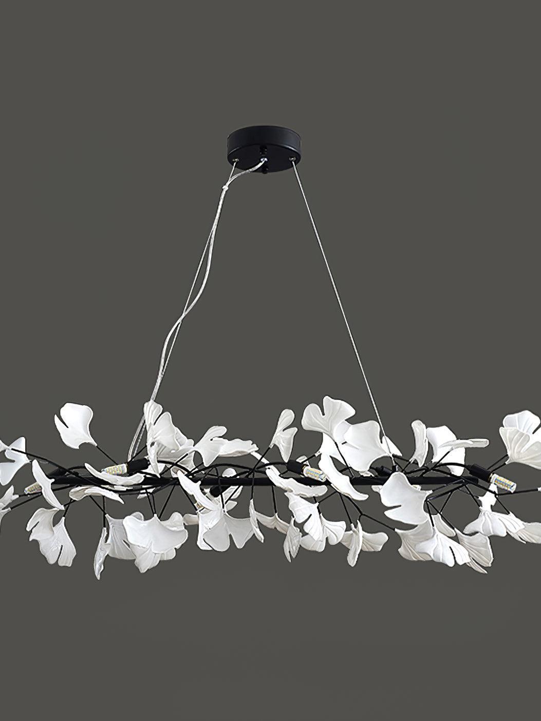 White leaf shapes on the black branching chandelier frame