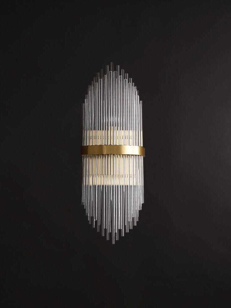 Unlit upright crystal rod wall sconce against black wall