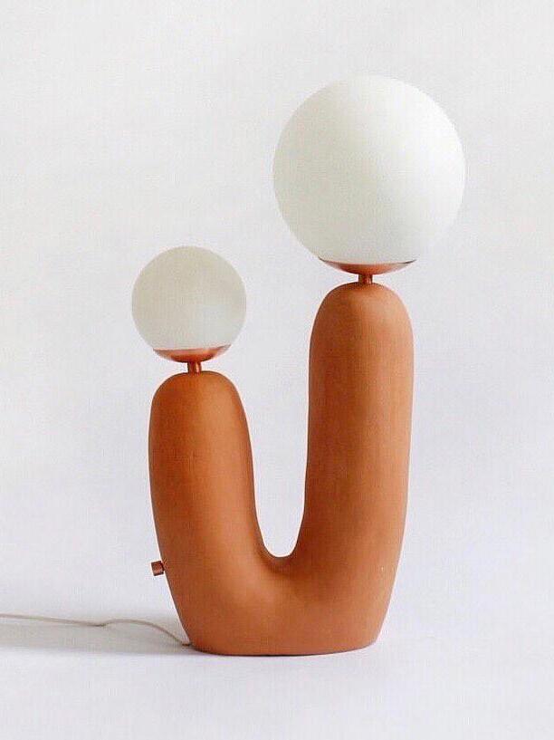 Terracotta-toned U-shaped body with two globes