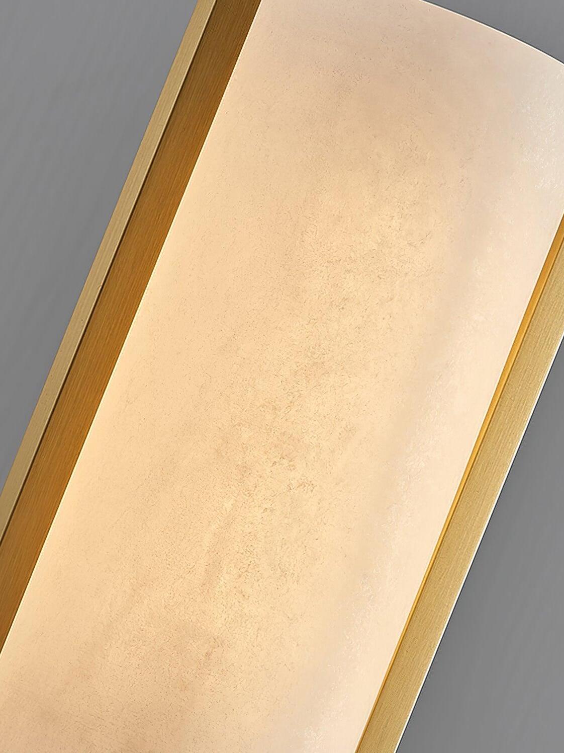 Close-up of the illuminated Melange stone surface between brass-coloured frame edges