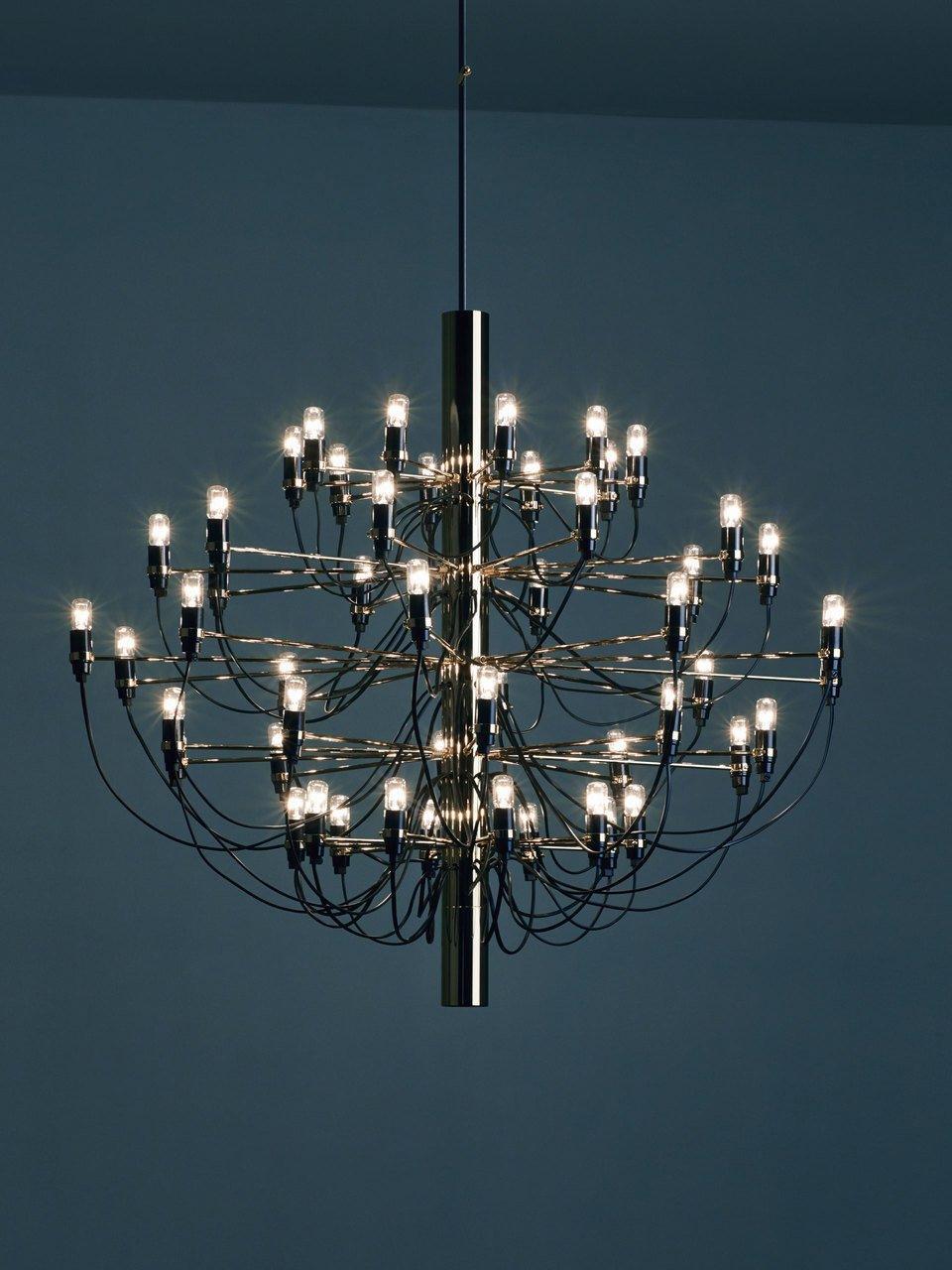 Illuminated tiered chandelier against a blue background
