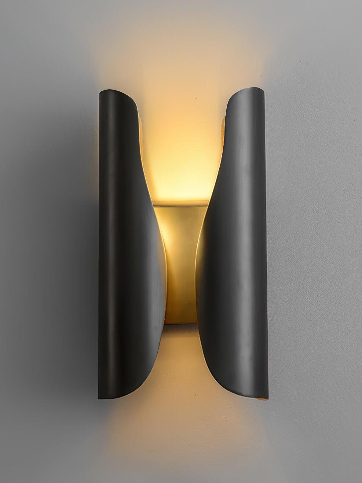 Blackened Guardian wall sconce with curved dark outer wings and an illuminated gold-toned centre