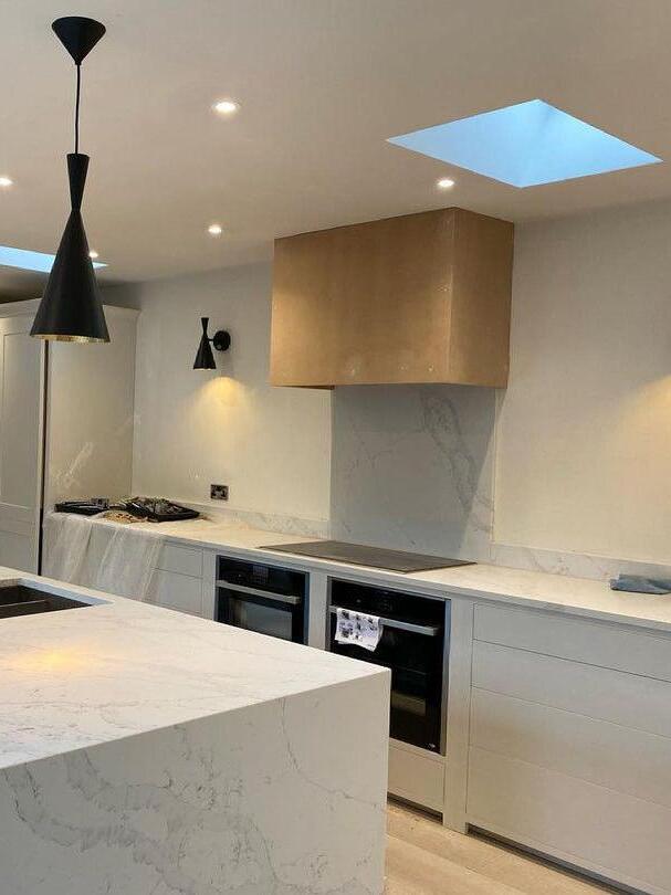 Kitchen scene with black wall light and separate ceiling pendant