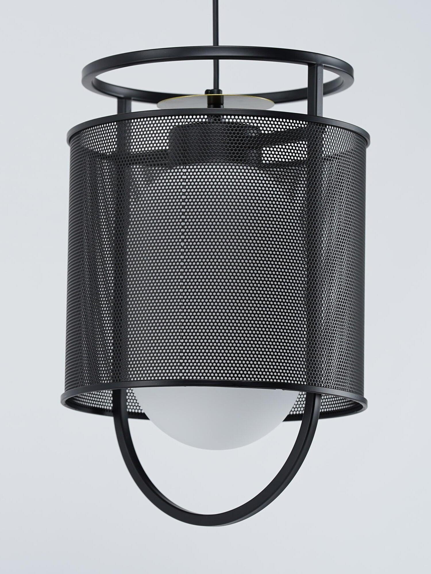 Unlit black mesh pendant and pale inner glass on light background