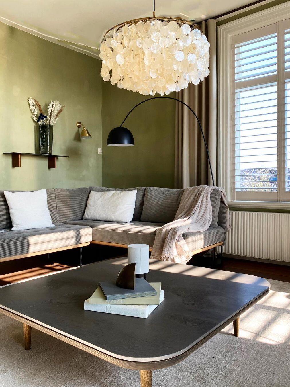 Large round shell chandelier above a sofa