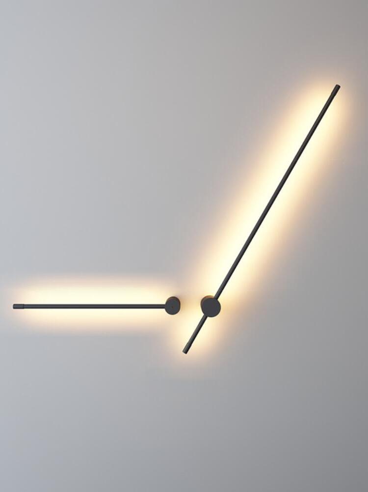Two angled black rods with light behind them