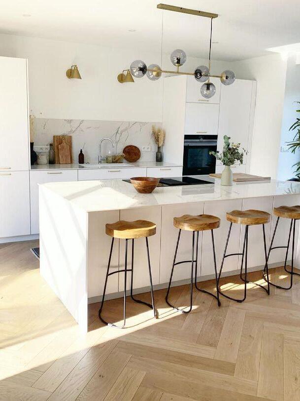 Orb chandelier above a bright kitchen island
