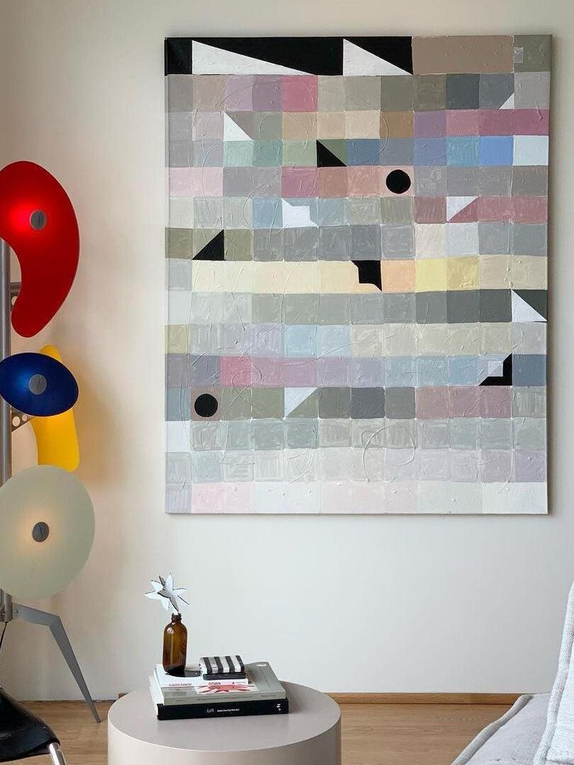 Partial multicolour floor lamp beside wall art