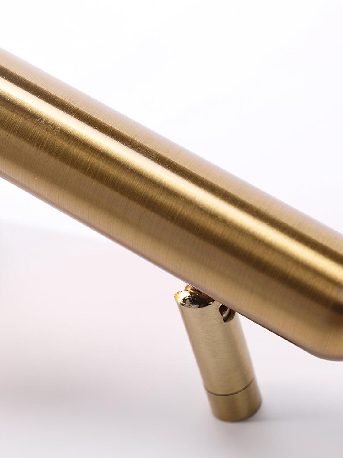 Close-up of the pivot joint beneath the Nights gold-tone head on a white backplate