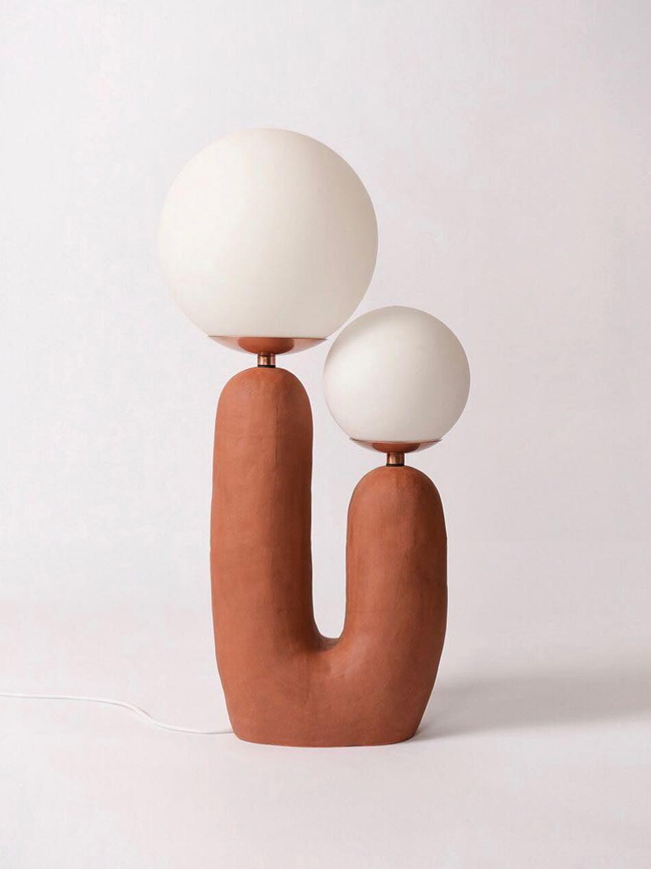 Terracotta-toned U-shaped lamp with two White globes