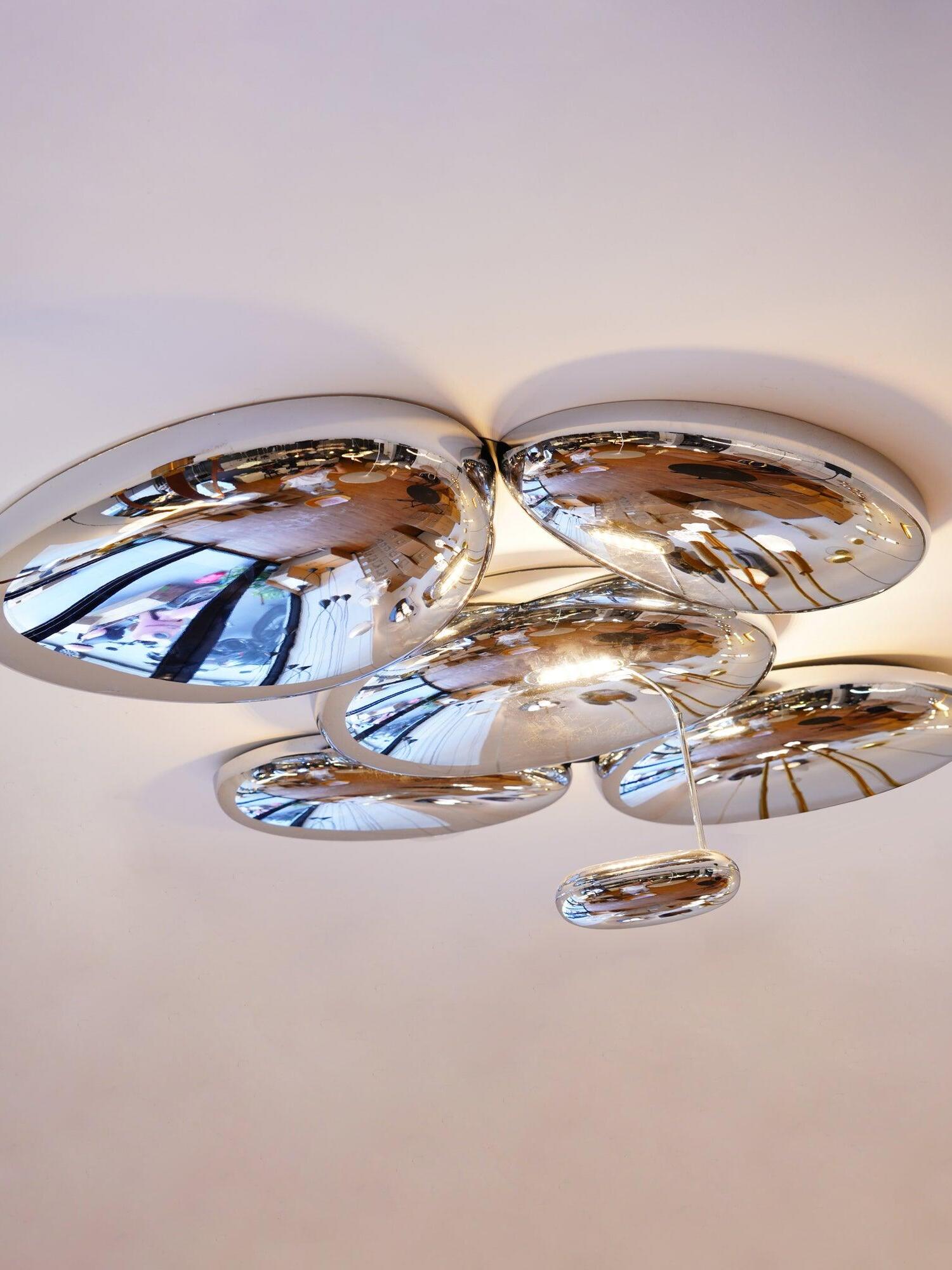 Five large reflective ceiling pebble forms and small oval hanging on slim stem
