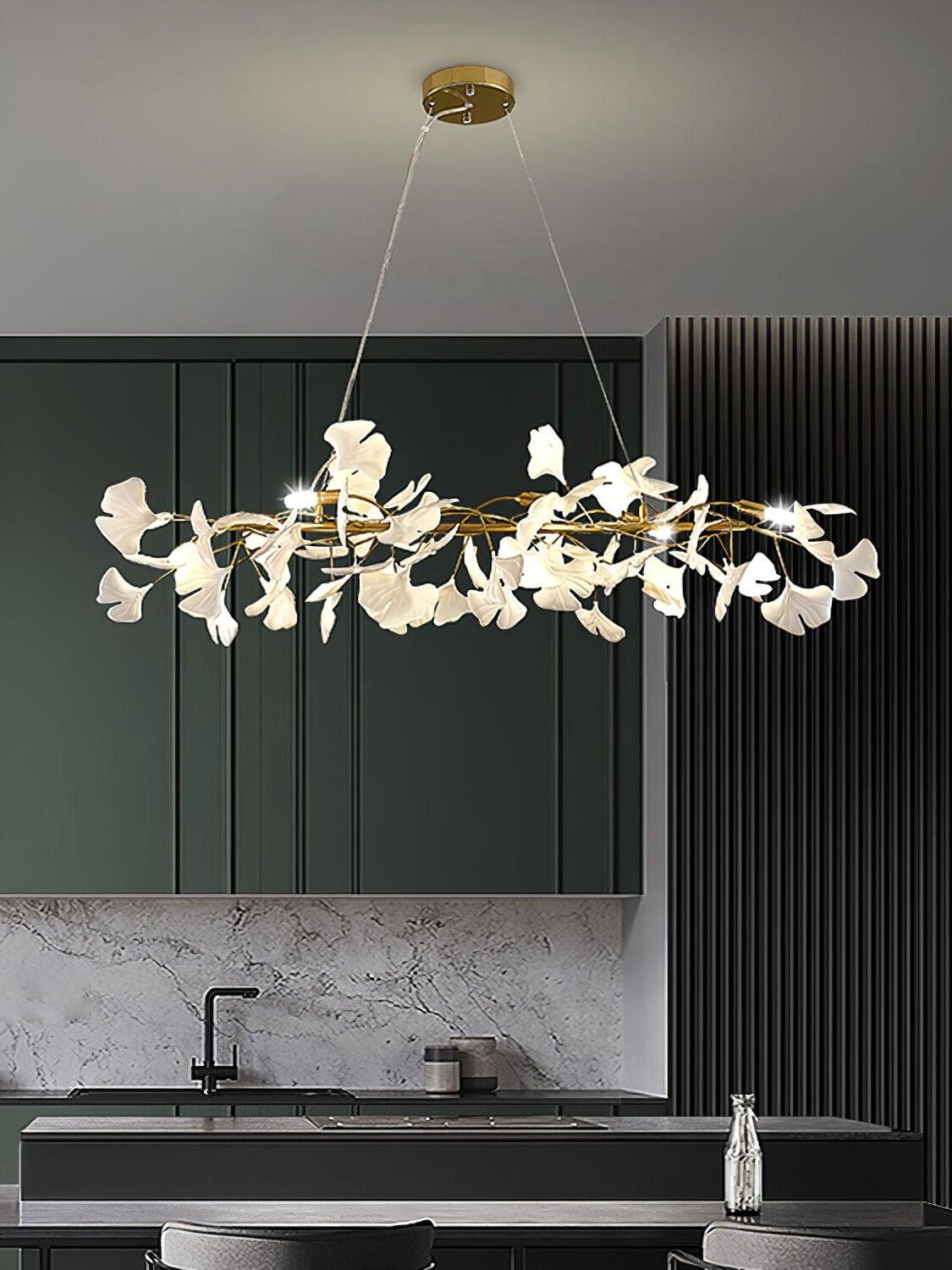 Elongated white-leaf chandelier above a kitchen island