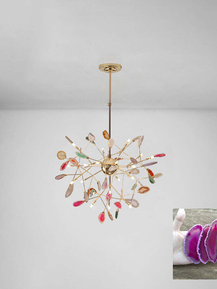 Radial multicoloured chandelier beneath a pale ceiling with a pink stone sample inset