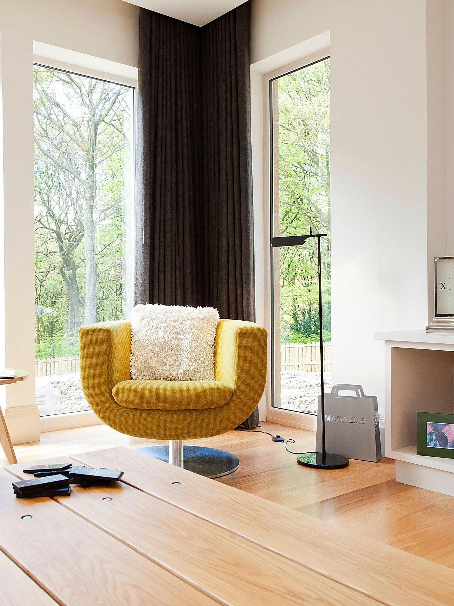 Black floor lamp in a seating area beside a yellow chair