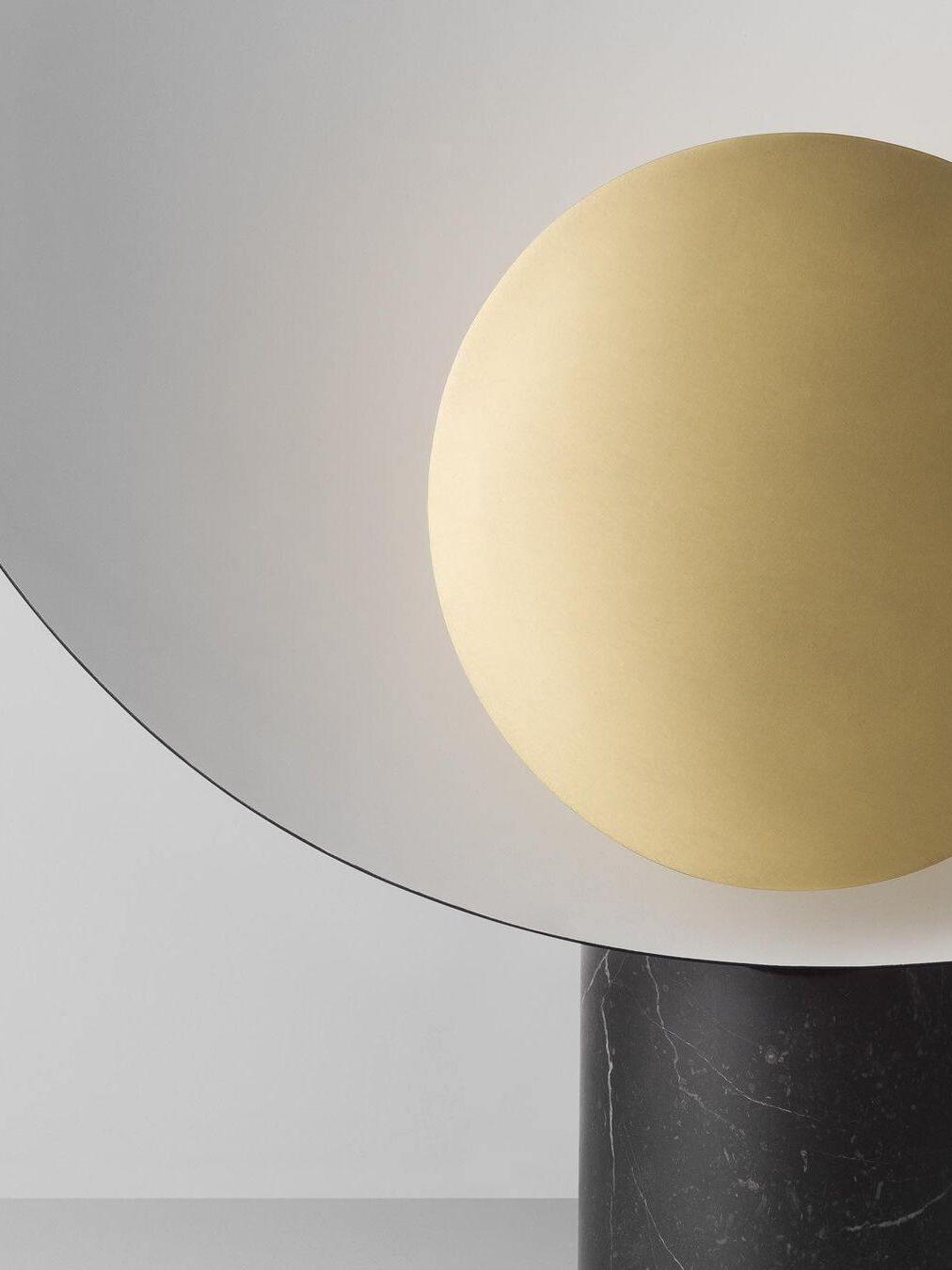 Close gold-tone circle within pale curved shade