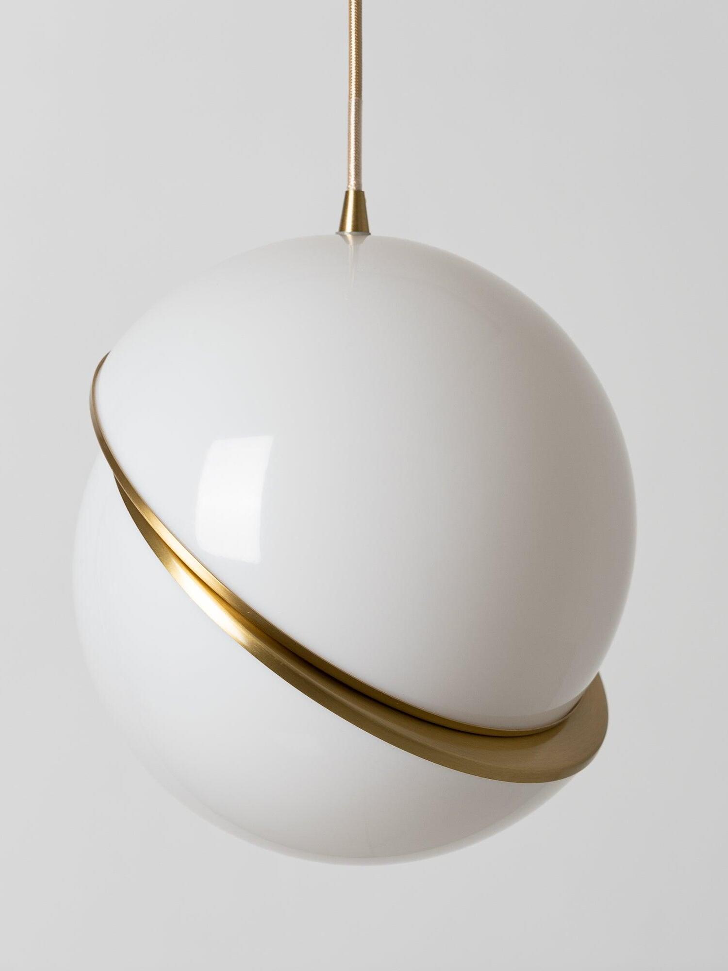 Unlit close view of Crescent offset white globe halves, gold-colour crescent band and upper cord connector