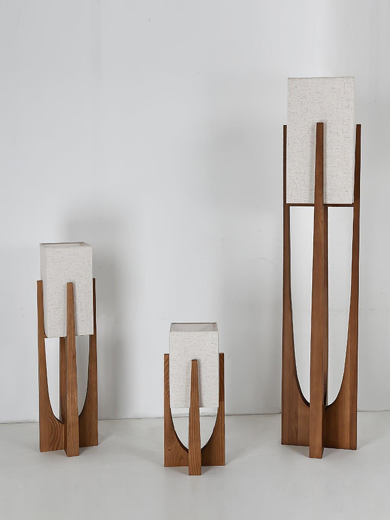 Three unlit Walnut wood lamp heights