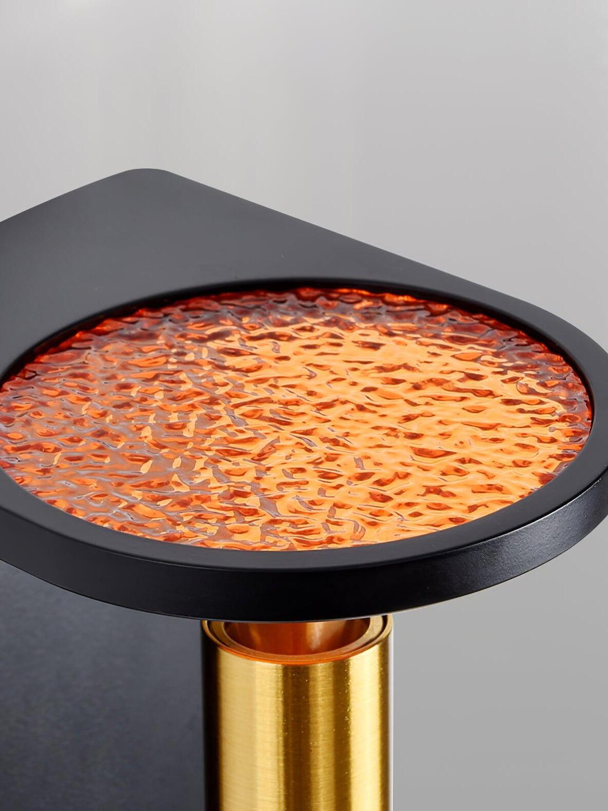 Close-up of the textured round upper light glowing orange within the black Nights frame