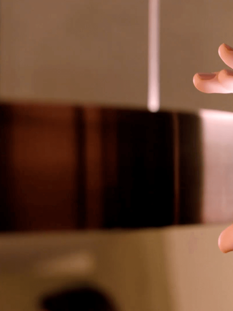 Hand near the edge of a metallic ring light