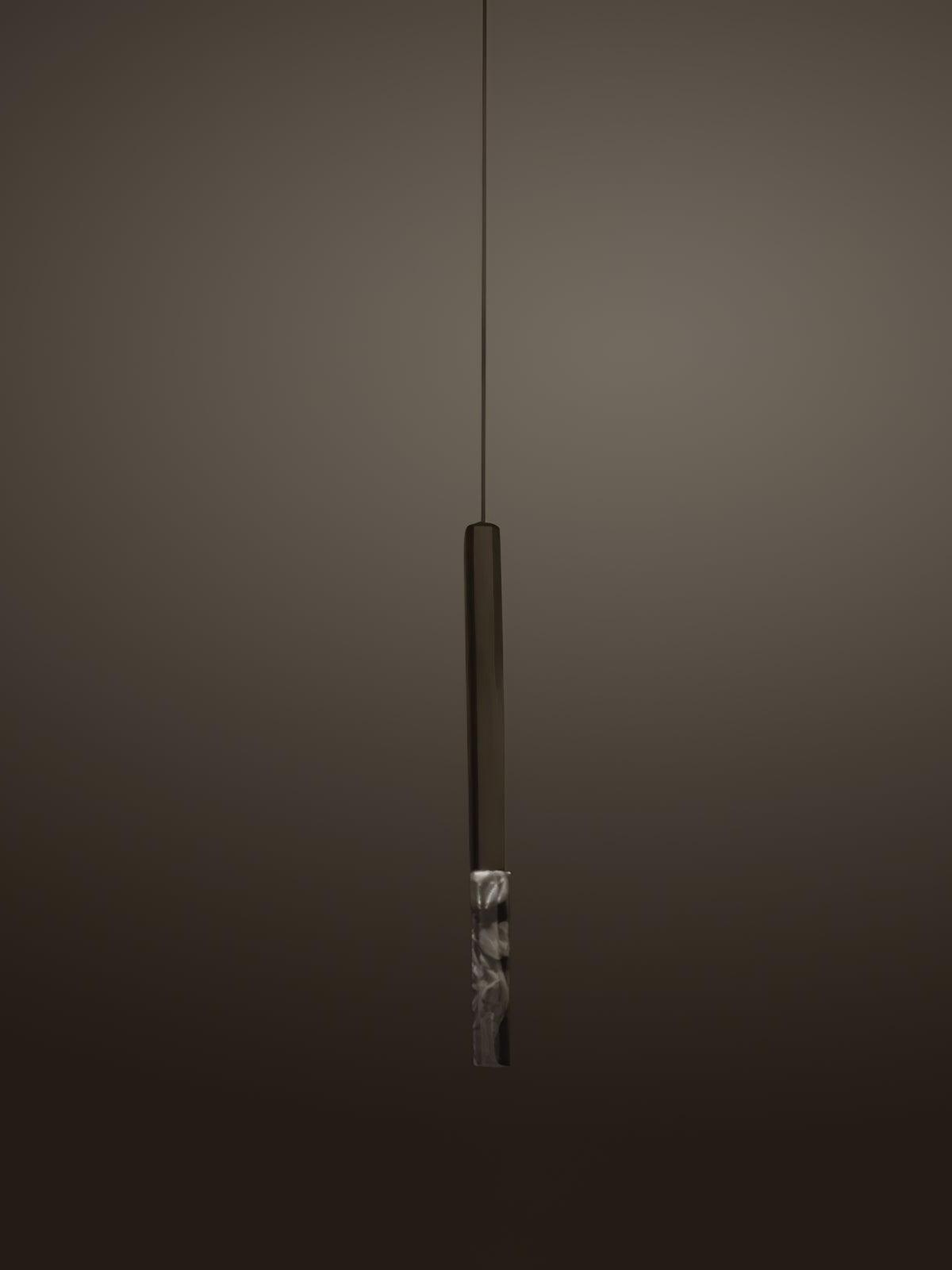 Single black vertical pendant with a clear lower block