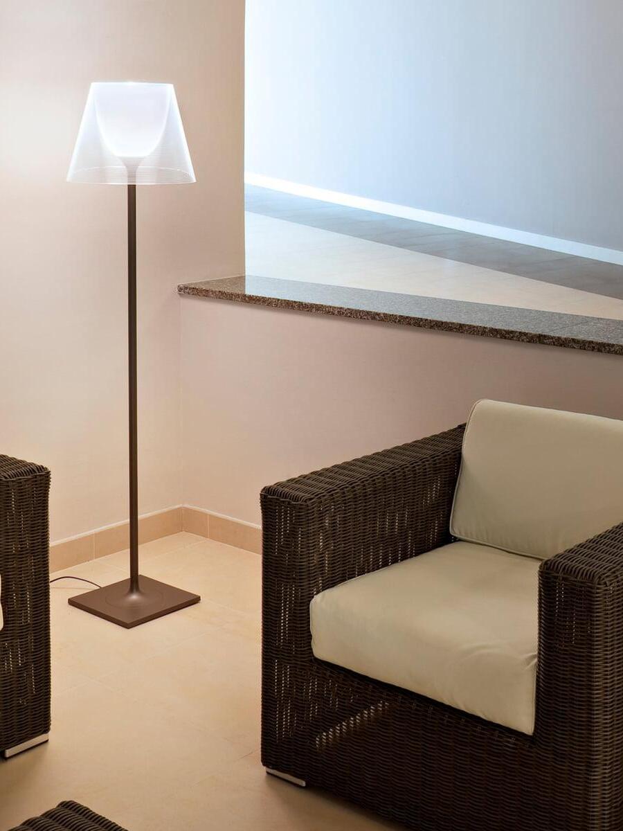 Ktribe clear-shade floor lamp beside indoor seating
