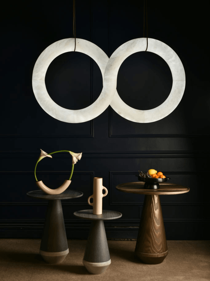 Two upright alabaster rings over display furniture