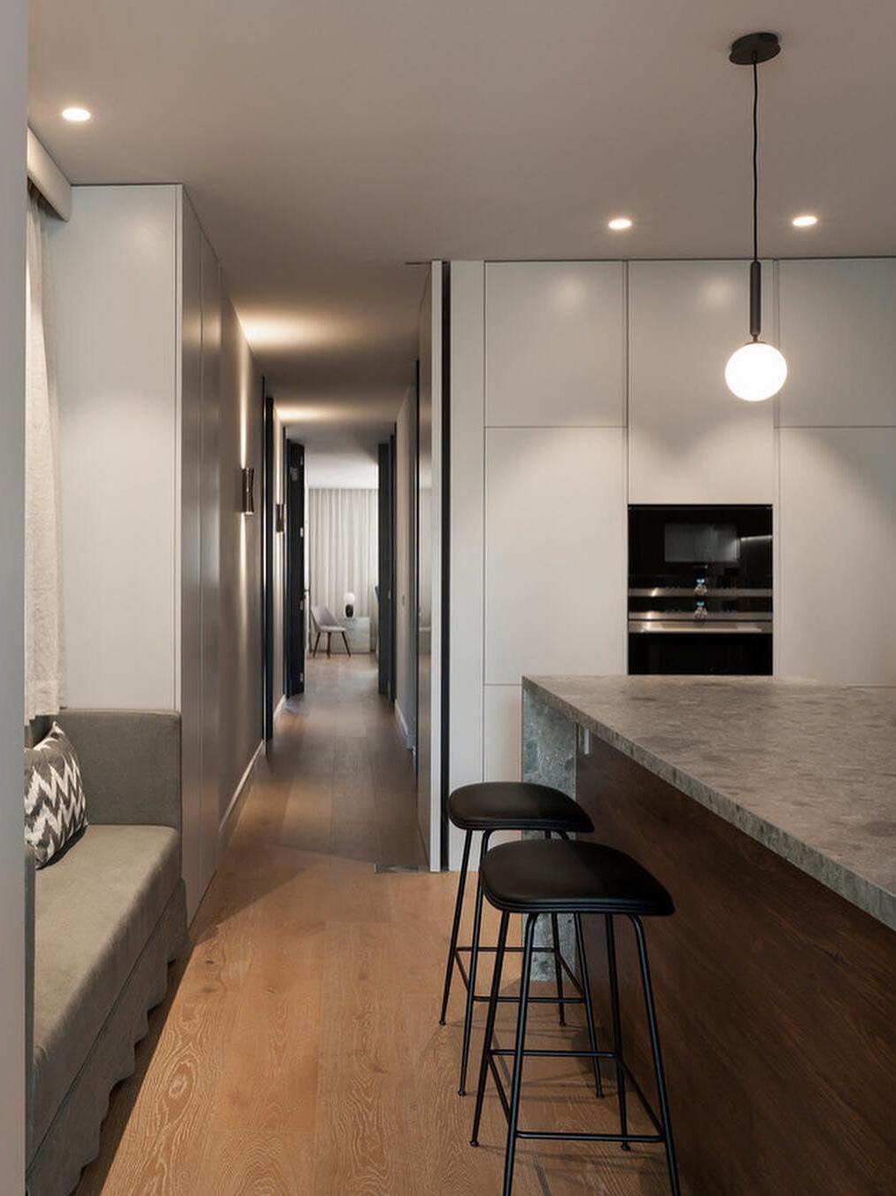 White single-globe pendants over a kitchen island