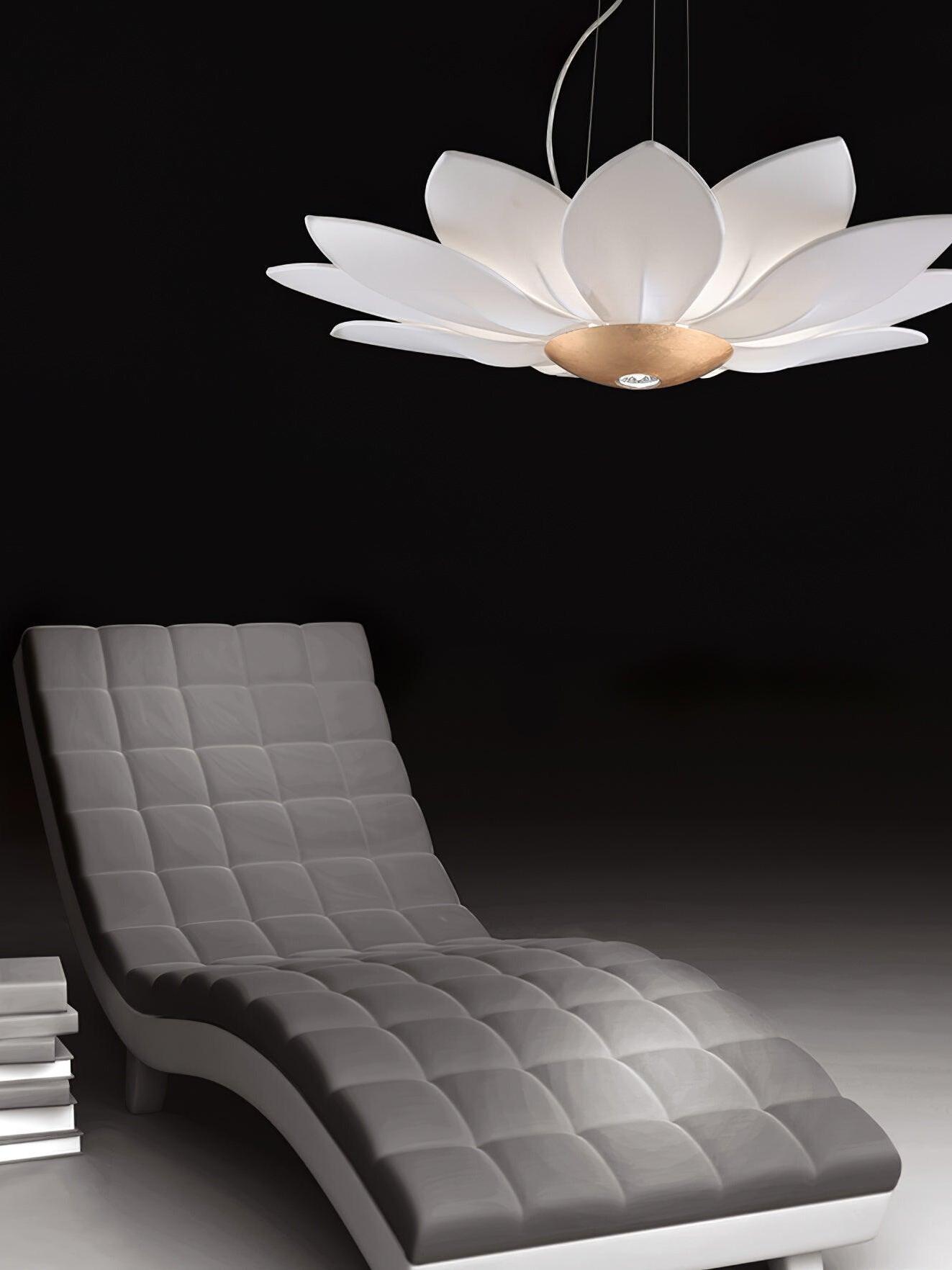 White floral chandelier glowing above grey lounge chair