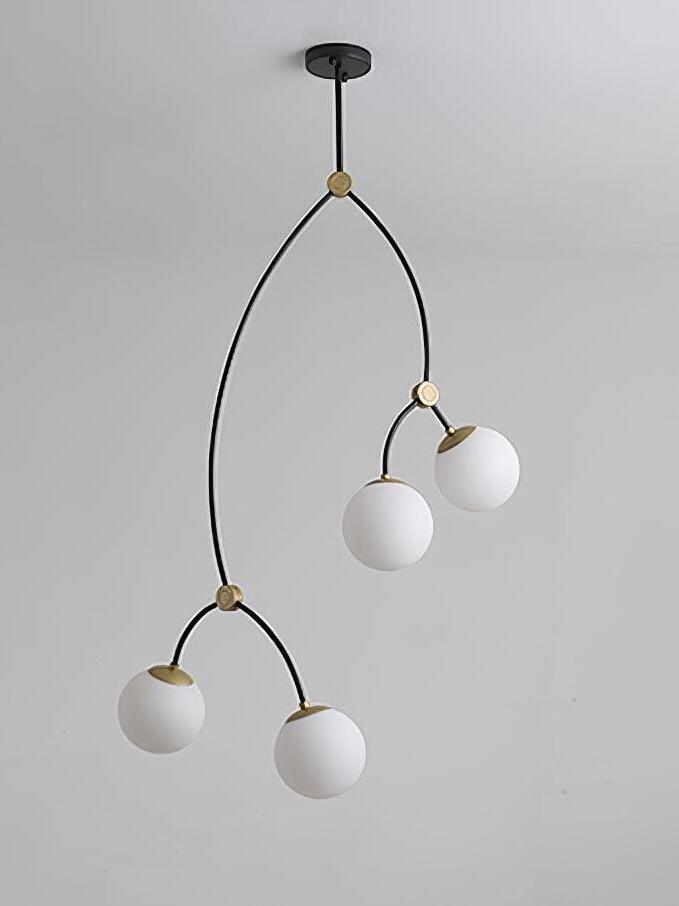 Four white glass globes on a tall branching black chandelier