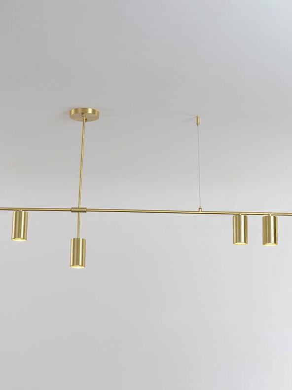 Gold-coloured linear chandelier and ceiling support lines