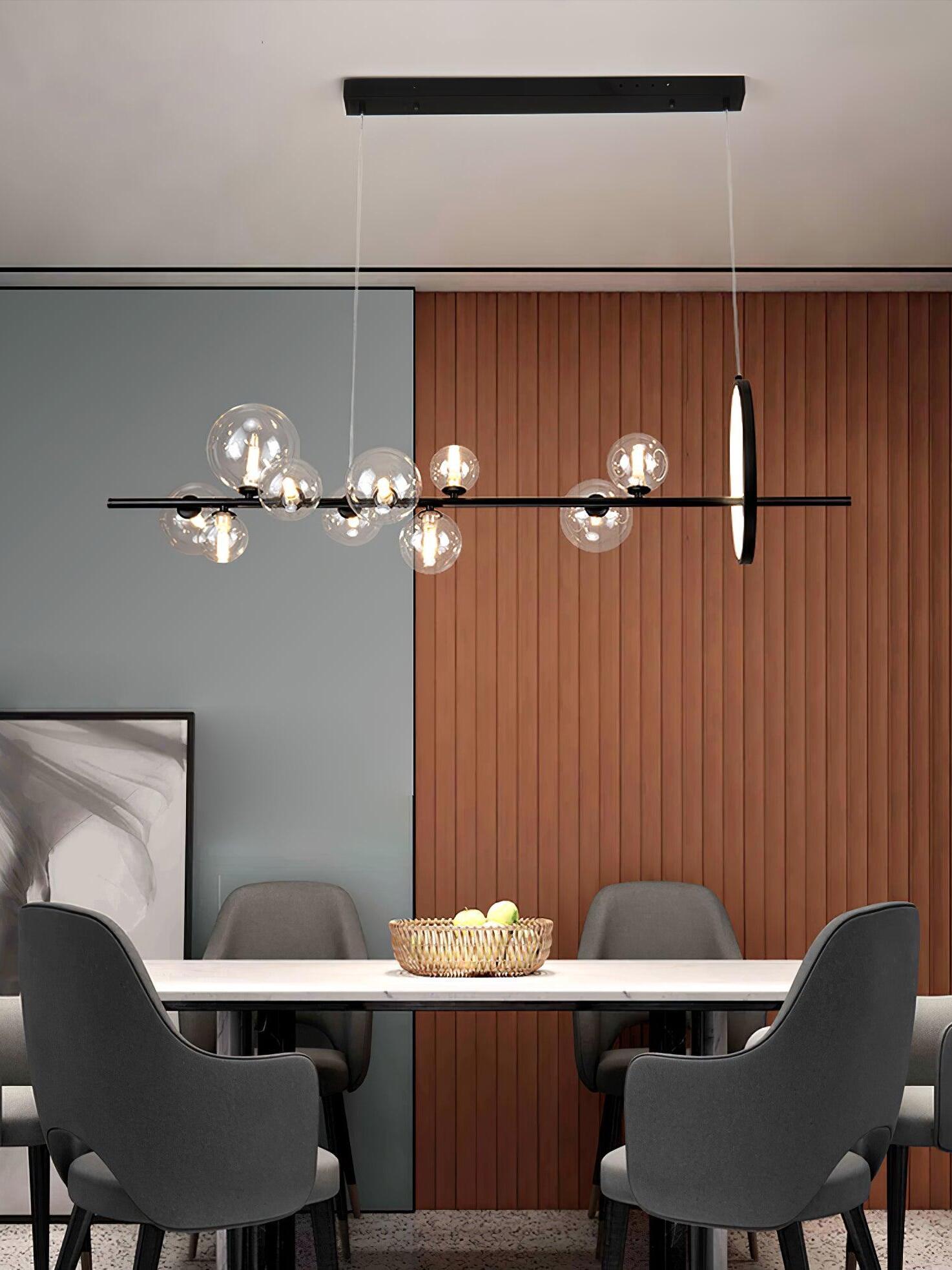 Clear-globe chandelier in a dining space with wood panels