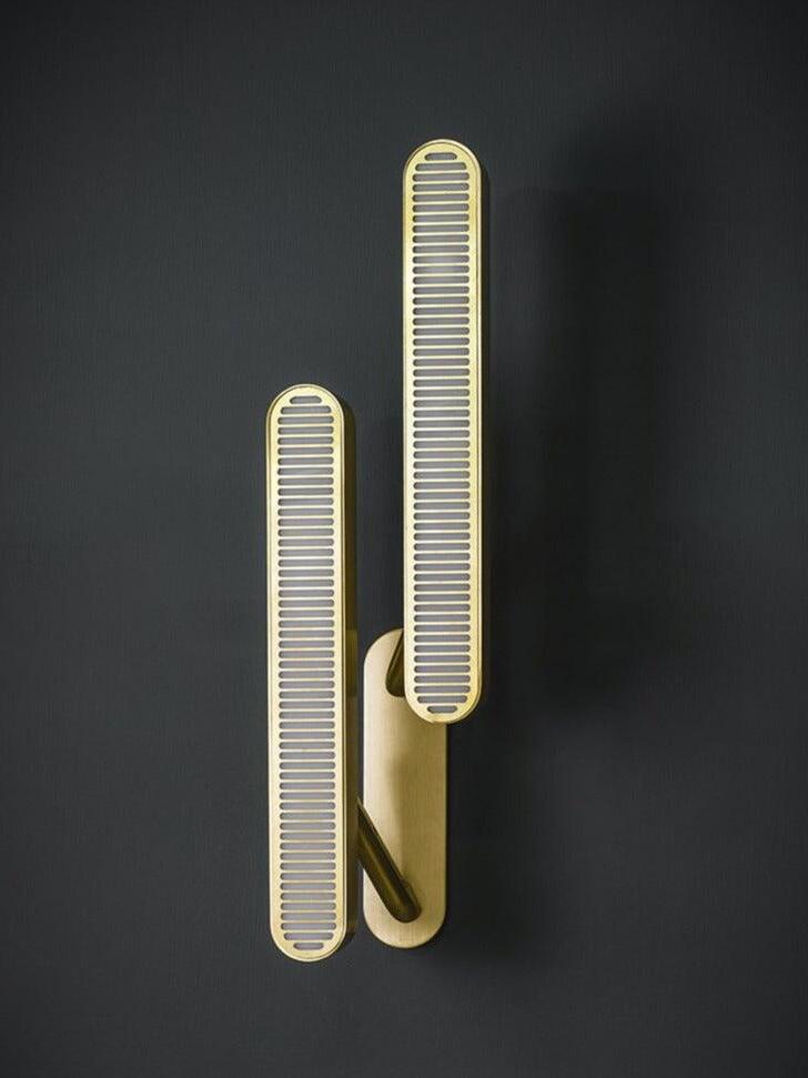 Tightly framed unlit staggered grille bars with gold-tone edges and common rounded backplate against Dark Gray
