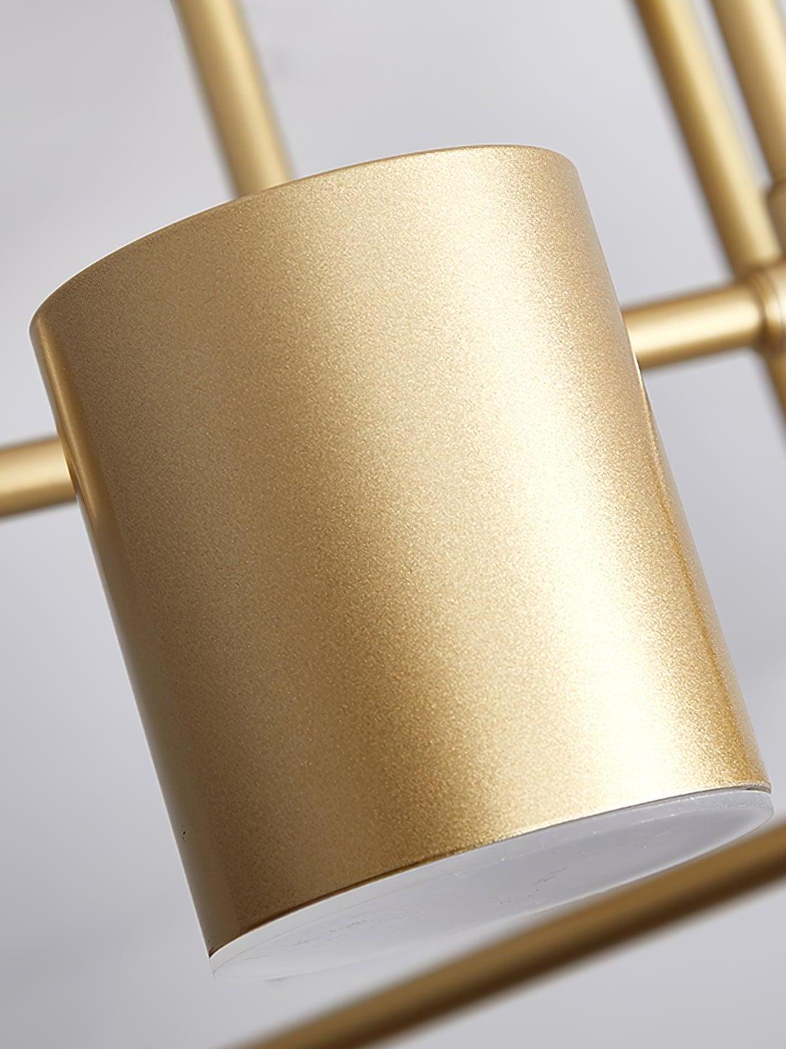 Close-up of a gold cylindrical light head with fine surface texture and a pale diffuser edge underneath