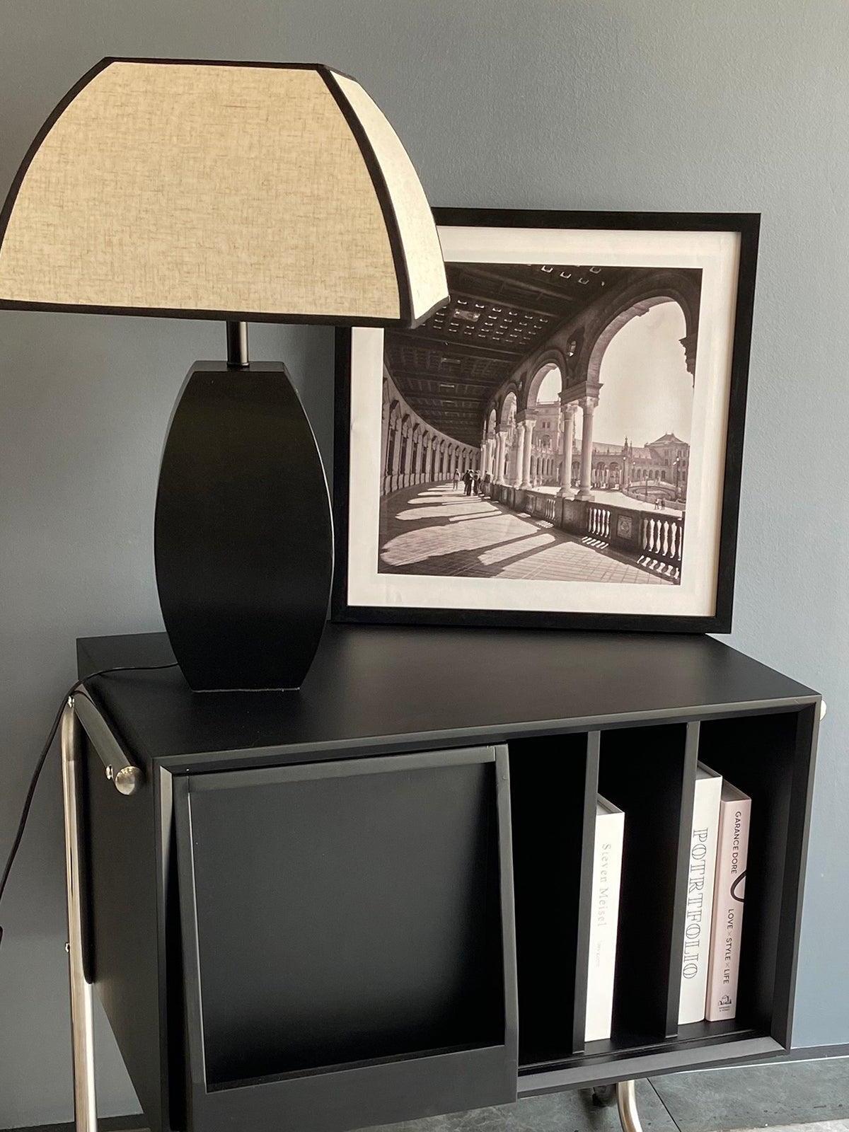 Javier table lamp on black shelving cabinet