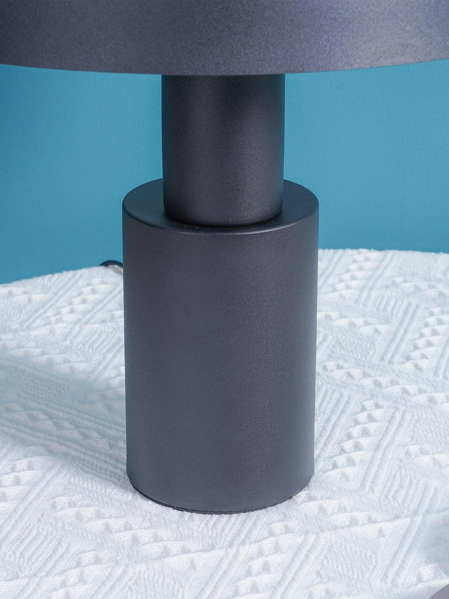 Close view of black cylindrical base and supports