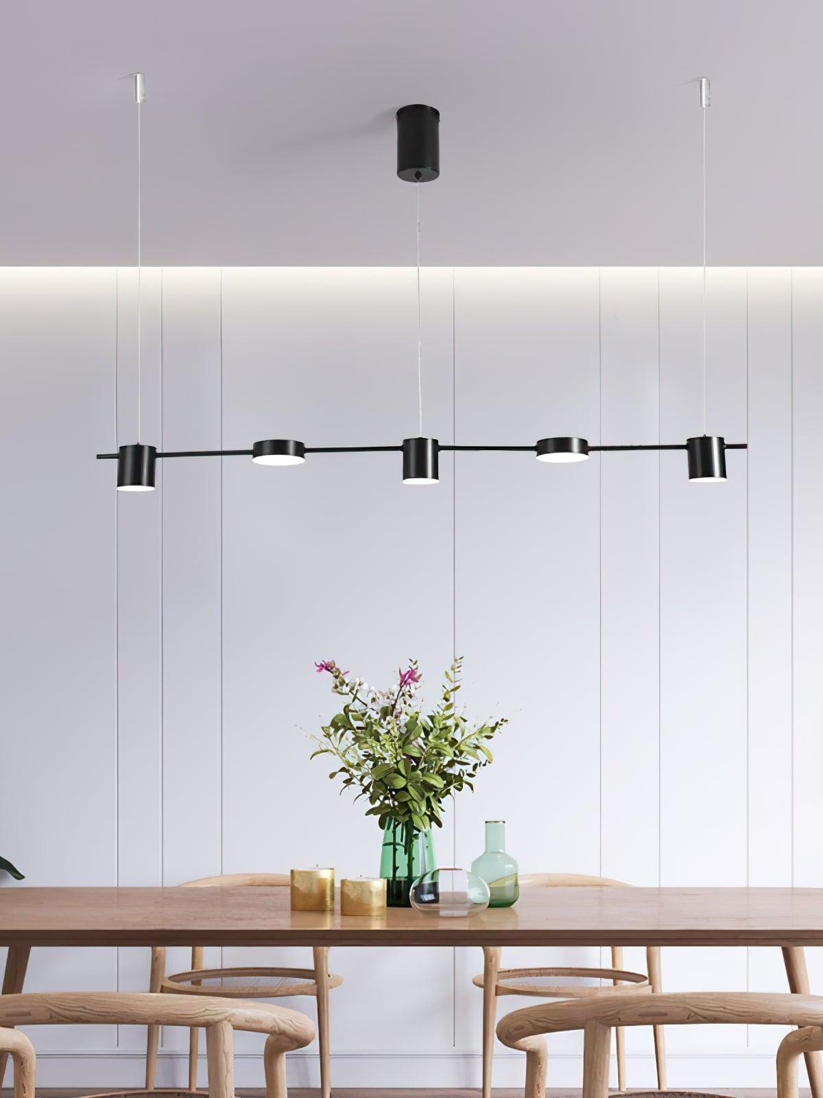 Black linear light above a table with flowers
