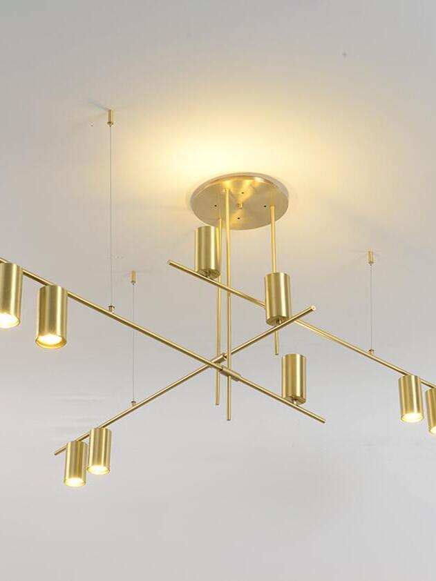 Gold-coloured rod arrangement against an illuminated ceiling
