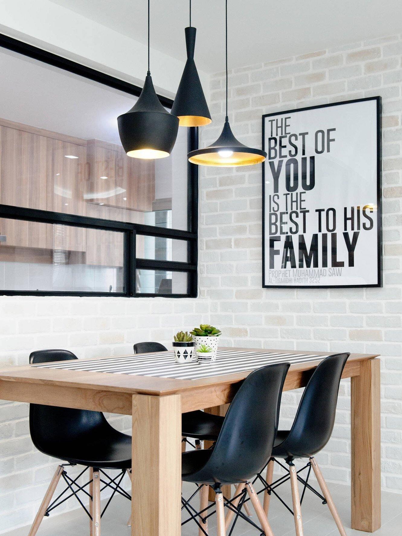 Black mixed-shape pendant group above a dining table
