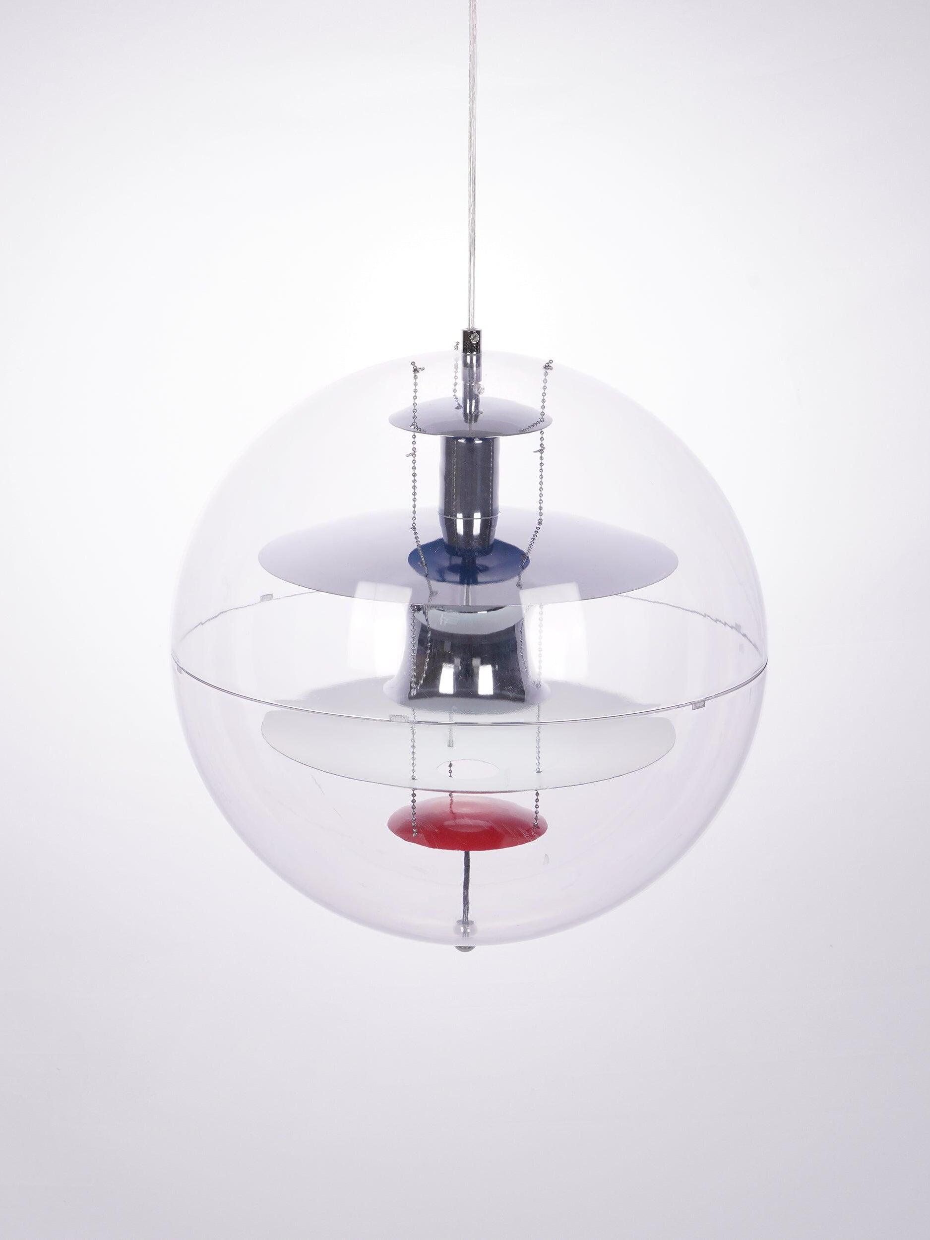 Angled clear globe pendant showing the reflective central form and small internal bead chains
